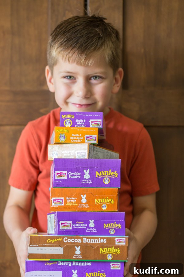 Southwestern-Style Mac and Cheese Cup Recipes for Game Day 2 Little boy holding a stack of various Annie's products.