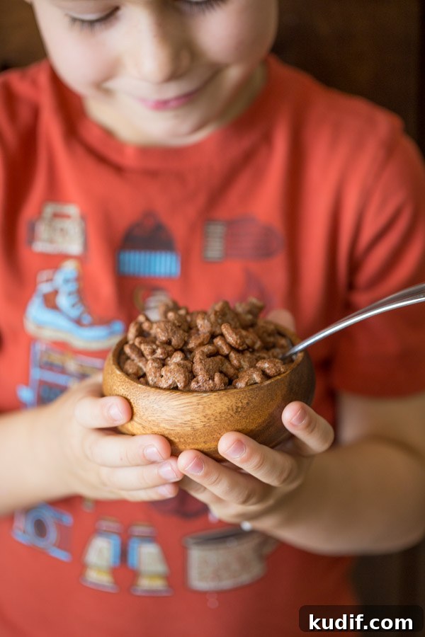 Southwestern-Style Mac and Cheese Cup Recipes for Game Day 3 Little boy holding a small bowl of Annie's Cocoa Bunnies.