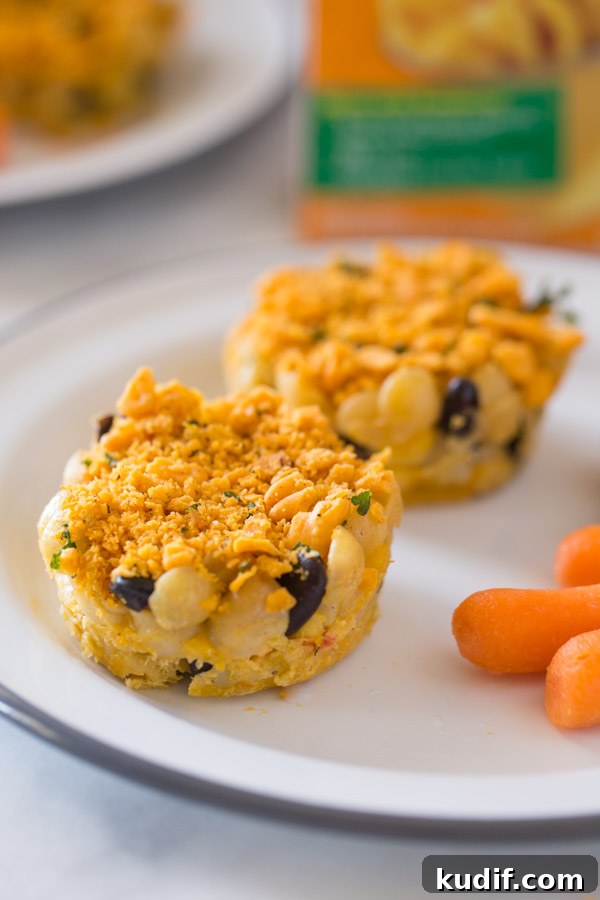 Southwestern-Style Mac and Cheese Cup Recipes for Game Day 8 Two Southwestern Mac and Cheese cups on a plate with some carrot sticks.