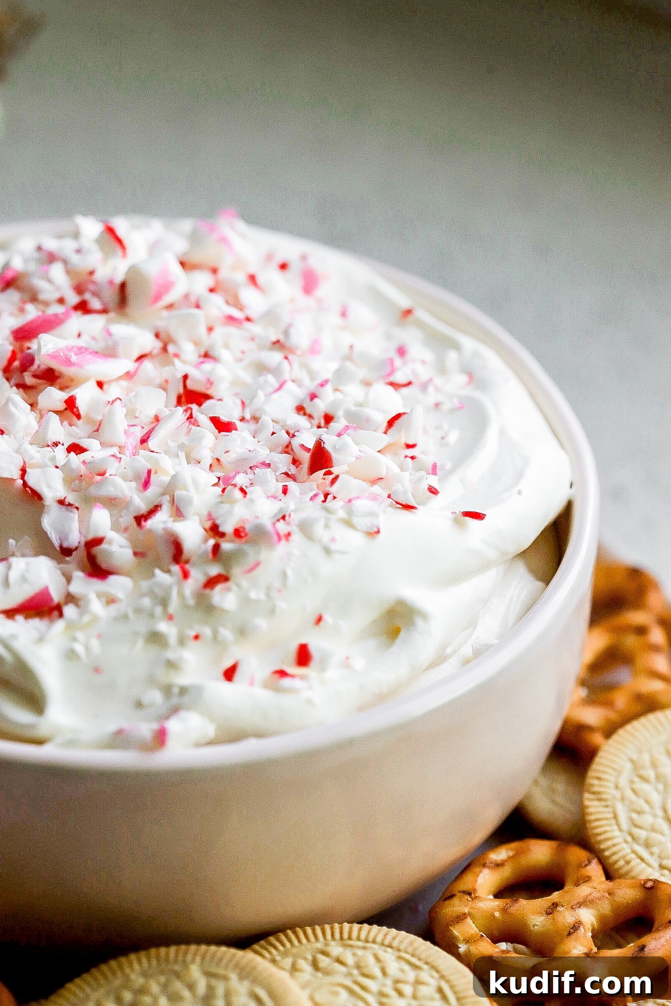 Peppermint Dessert Dip for Christmas Parties 5 Close up shot of holiday dessert dip with crushed candy canes on top.