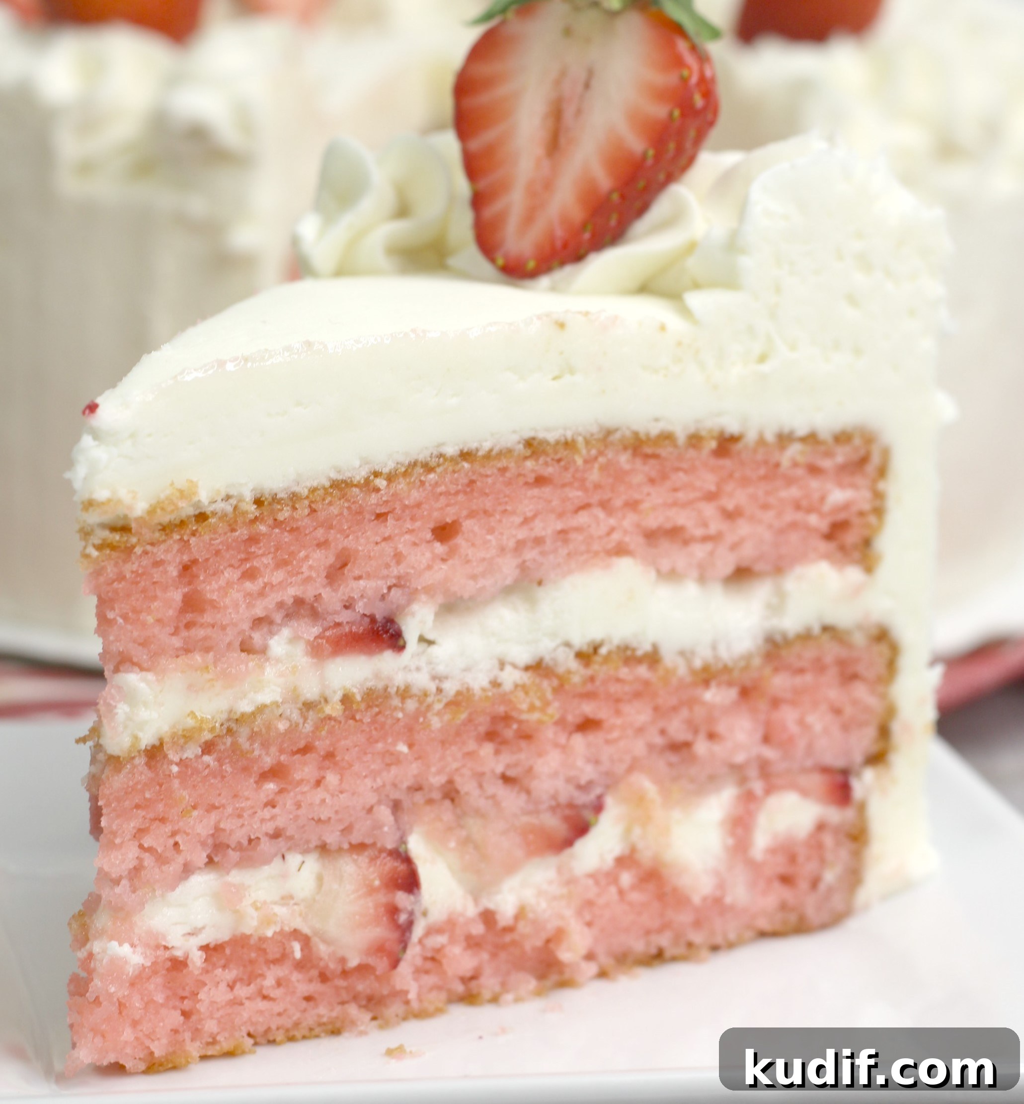 Strawberry Moscato Cake with Cream Cheese Buttercream 3 Strawberry Moscato Cake with Cream Cheese Buttercream Frosting on a white plate