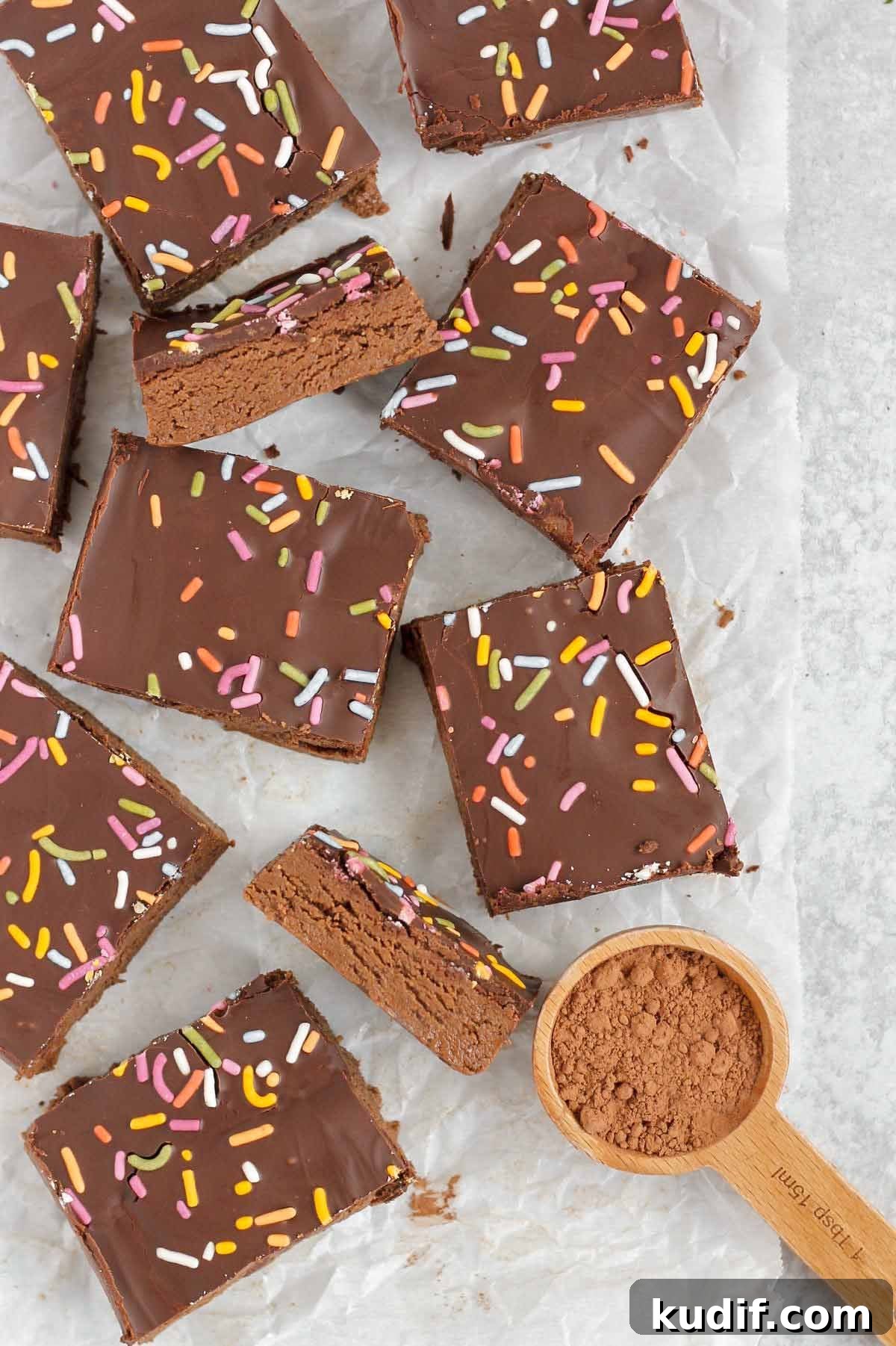 Cut up chocolate protein bars on crinkled white parchment paper.