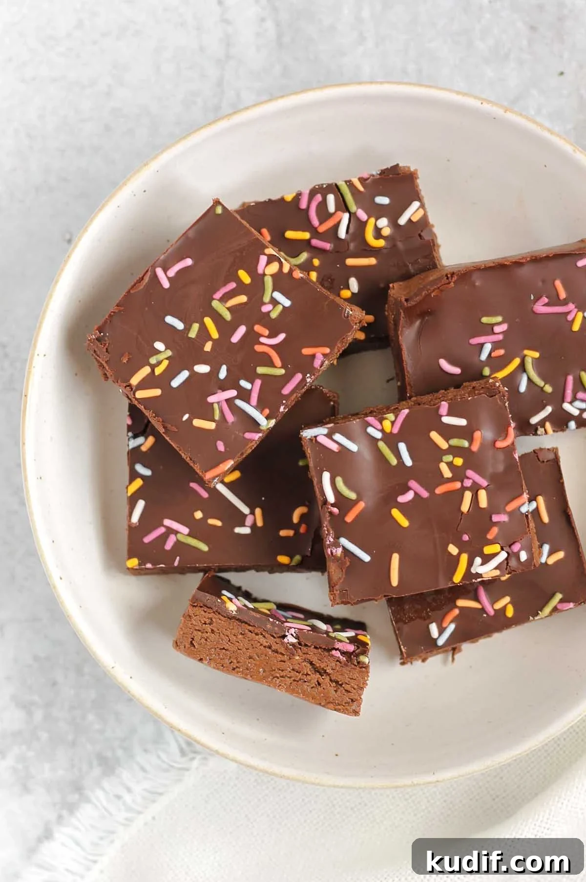 Chocolate protein with sprinkles laid out on a white plate.
