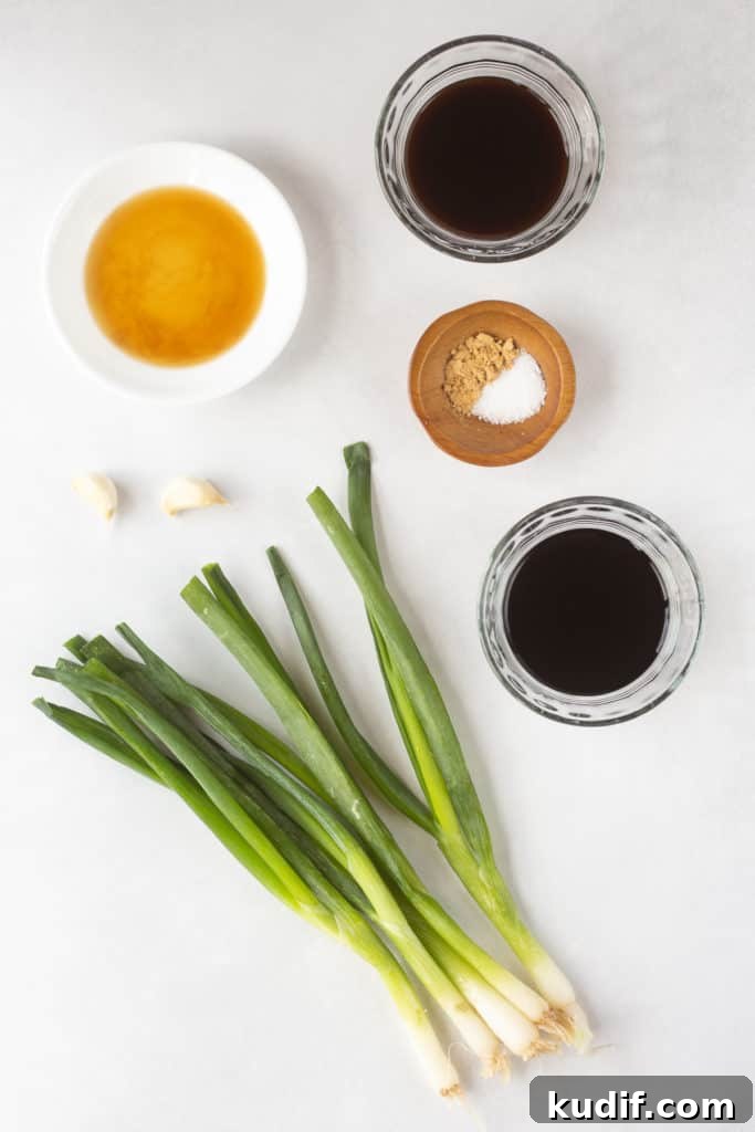 Gluten-Free Teriyaki Marinade Recipe for Stir-Fries & Grilling 4 Top down shot of ingredients for a teriyaki marinade in clear and white bowls, as well as two cloves of garlic and five fresh green onions.
