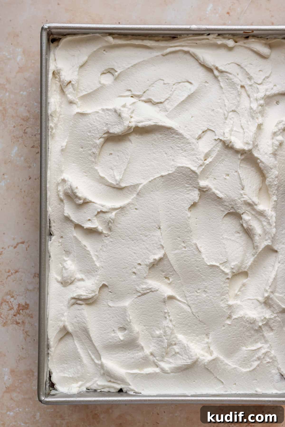 Coconut Tres Leches Cake Recipe — Moist Latin-Style Dessert 15 Whipped cream spread on top of the tres leches cake.