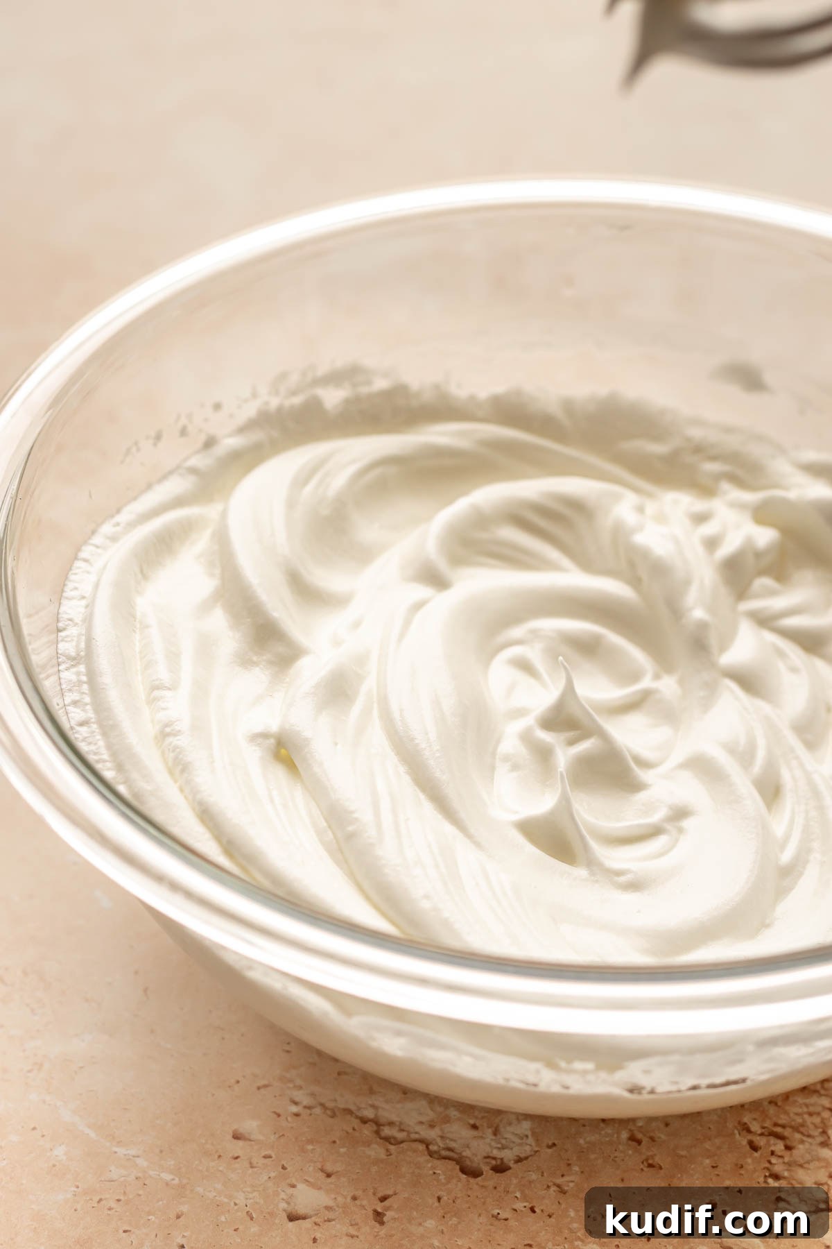 Coconut Tres Leches Cake Recipe — Moist Latin-Style Dessert 6 Whipped egg whites in a bowl.