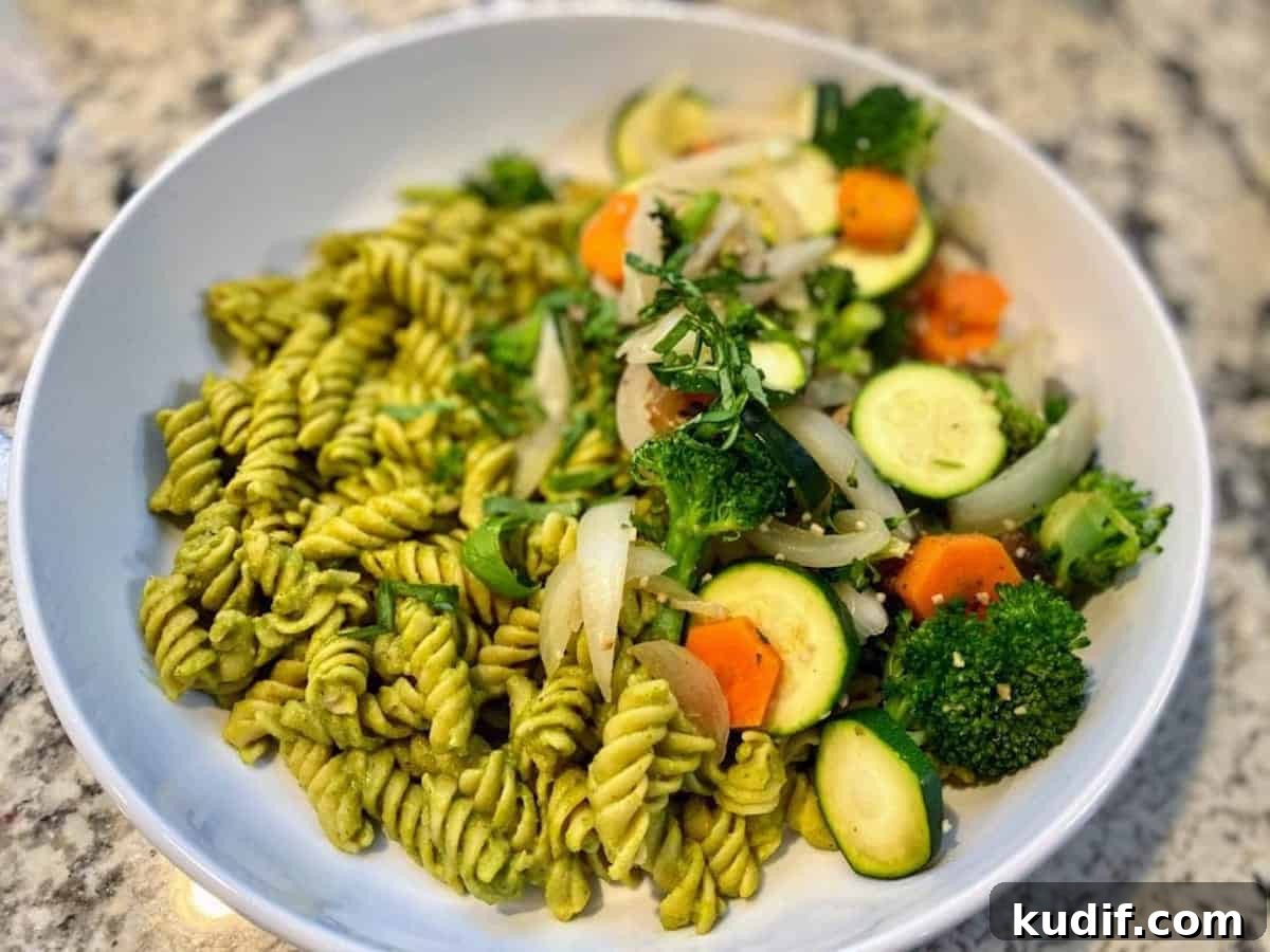 Vegan pesto pasta recipe in a bowl on the counter.