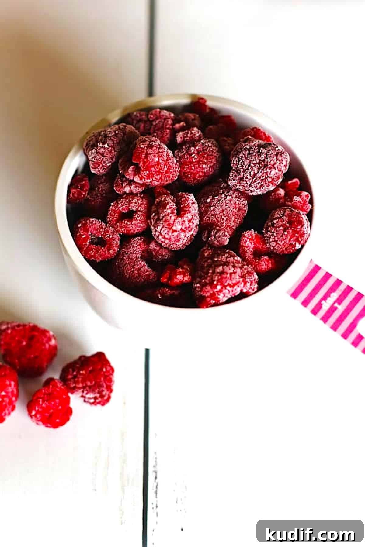 Freeze Raspberries for Smoothies and Desserts: Simple Step-by-Step Guide 4 Frozen raspberries in a measuring cup