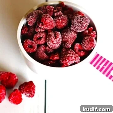 Freeze Raspberries for Smoothies and Desserts: Simple Step-by-Step Guide 10 Frozen raspberries in a measuring cup