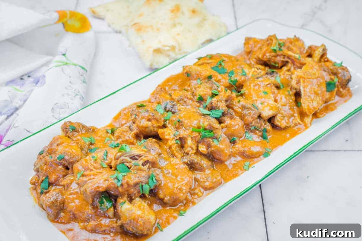 31 Delicious Recipes That Deliver Big Flavor with Little Effort 12 A rectangular plate of Chicken Tikka Masala with herbs on top.