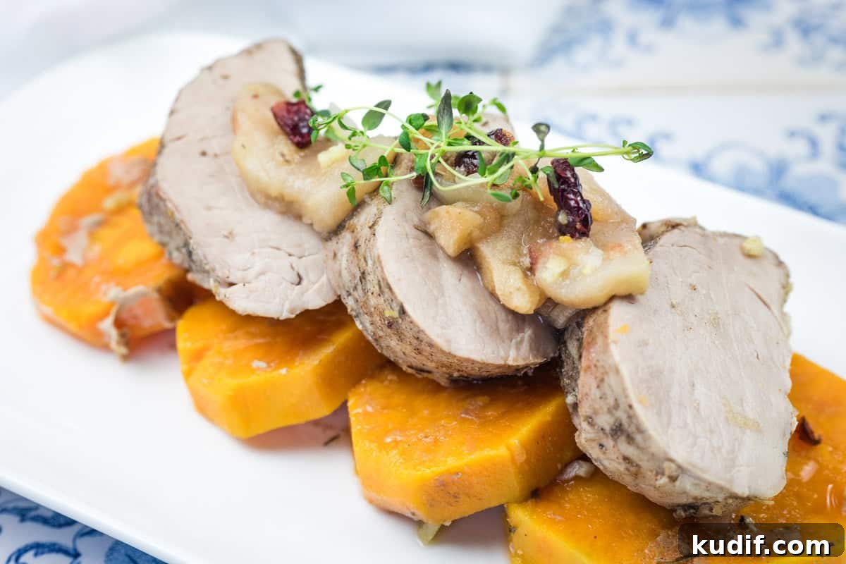 31 Delicious Recipes That Deliver Big Flavor with Little Effort 17 A serving of Slow Cooker Pork Tenderloin with Sweet Potatoes & Apples on a white platter.