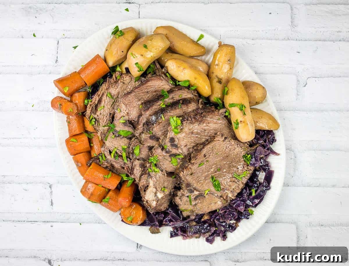 31 Delicious Recipes That Deliver Big Flavor with Little Effort 19 A plate of German pot roast beef with a sauce being poured over it.