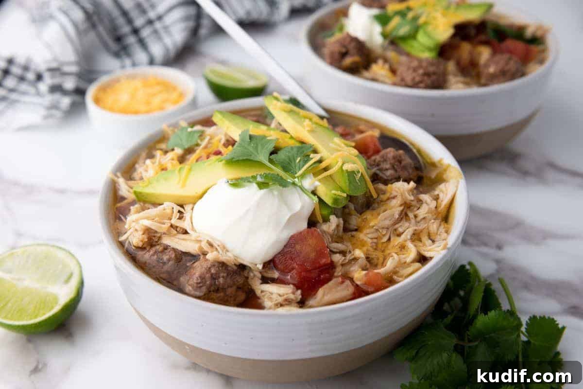 31 Delicious Recipes That Deliver Big Flavor with Little Effort 24 Two bowls of Slow-Cooker Taco Soup next to sliced lime.