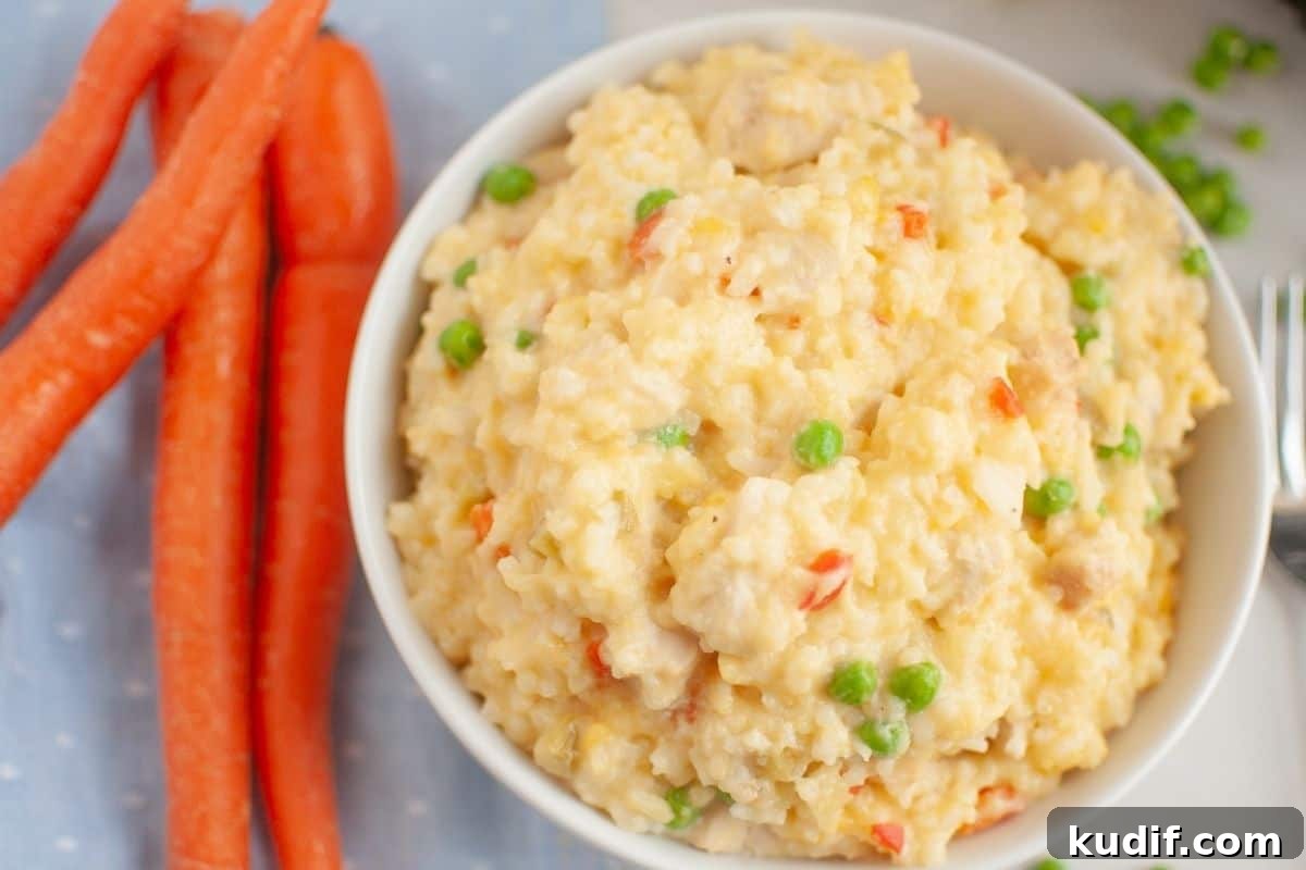31 Delicious Recipes That Deliver Big Flavor with Little Effort 26 A bowl of Slow Cooker Chicken and Rice is next to whole carrots on a light blue cloth.