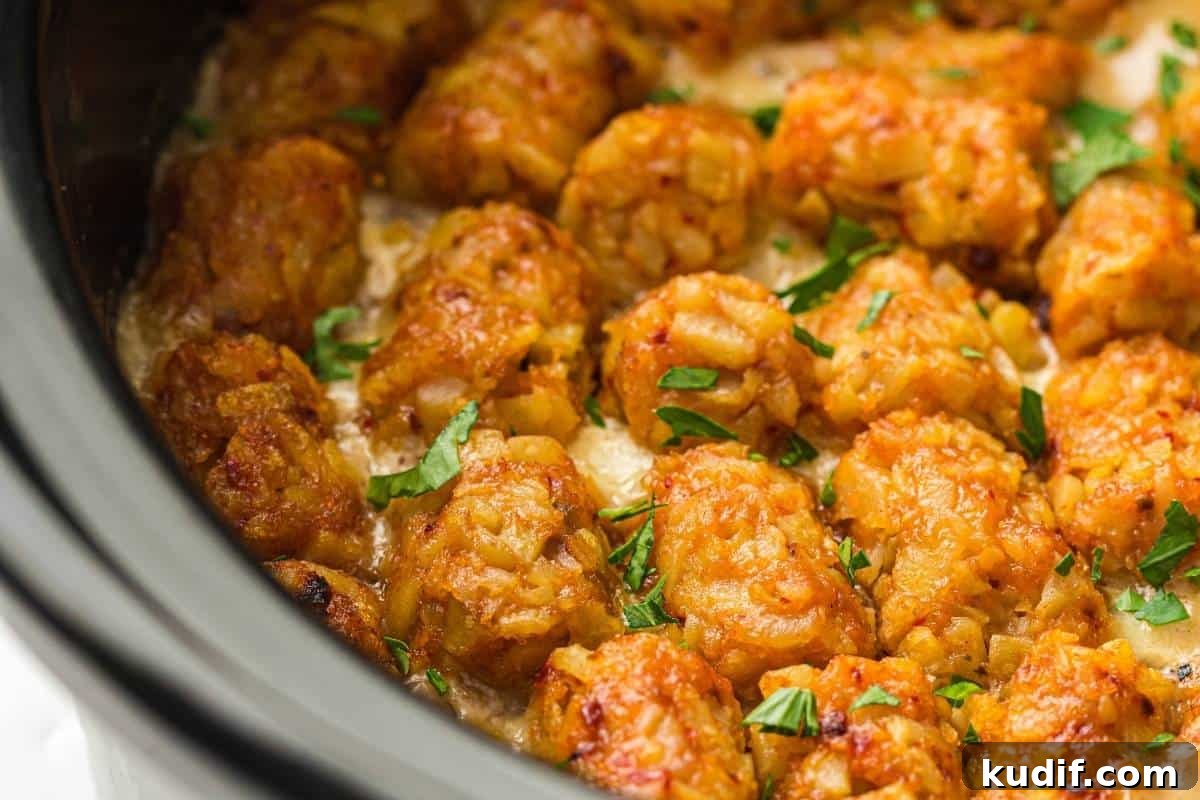 31 Delicious Recipes That Deliver Big Flavor with Little Effort 29 Close-up of Slow Cooker Cowboy Casserole garnished with chopped parsley, inside a slow cooker.