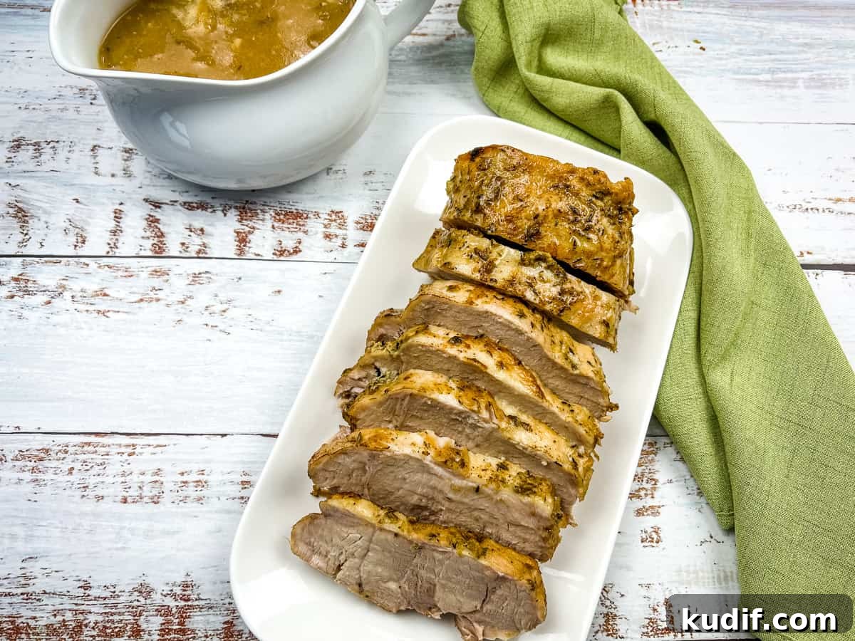 31 Delicious Recipes That Deliver Big Flavor with Little Effort 30 German Pork Loin on a platter with a gravy boat nearby.