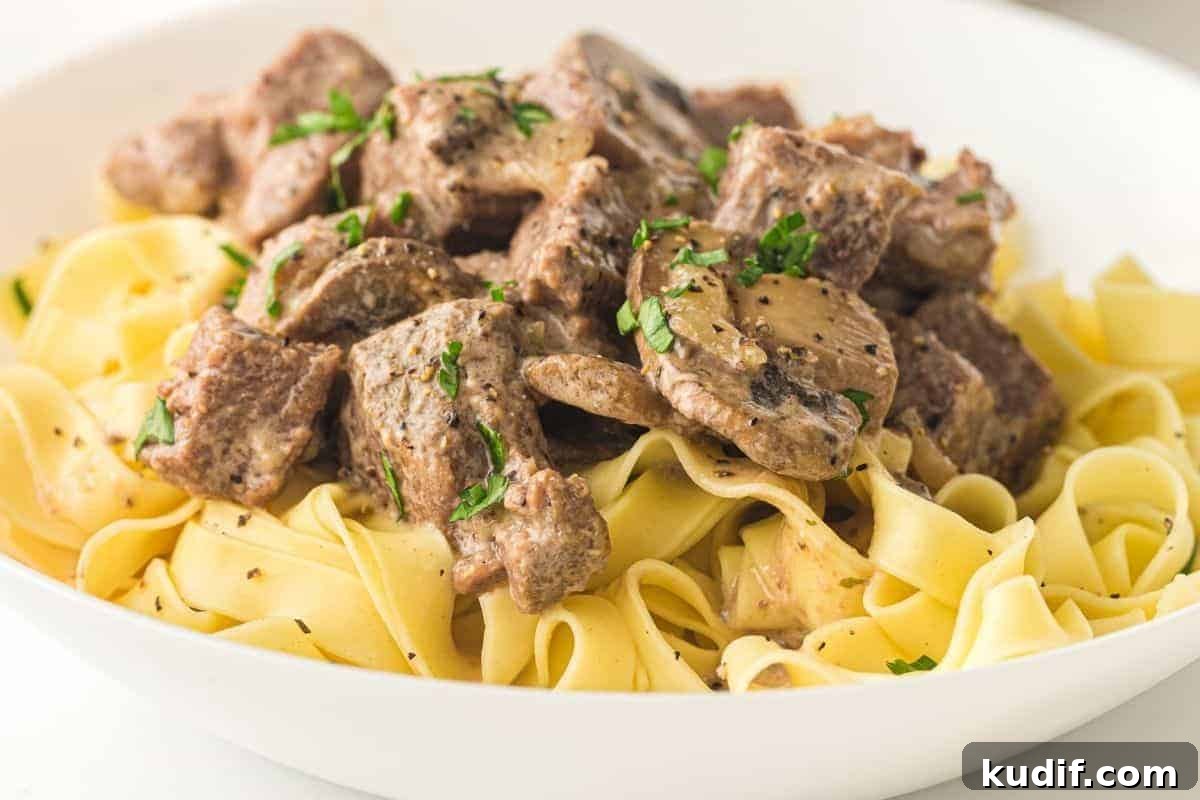 31 Delicious Recipes That Deliver Big Flavor with Little Effort 4 A plate of Slow Cooker Beef Stroganoff garnished with chopped parsley.