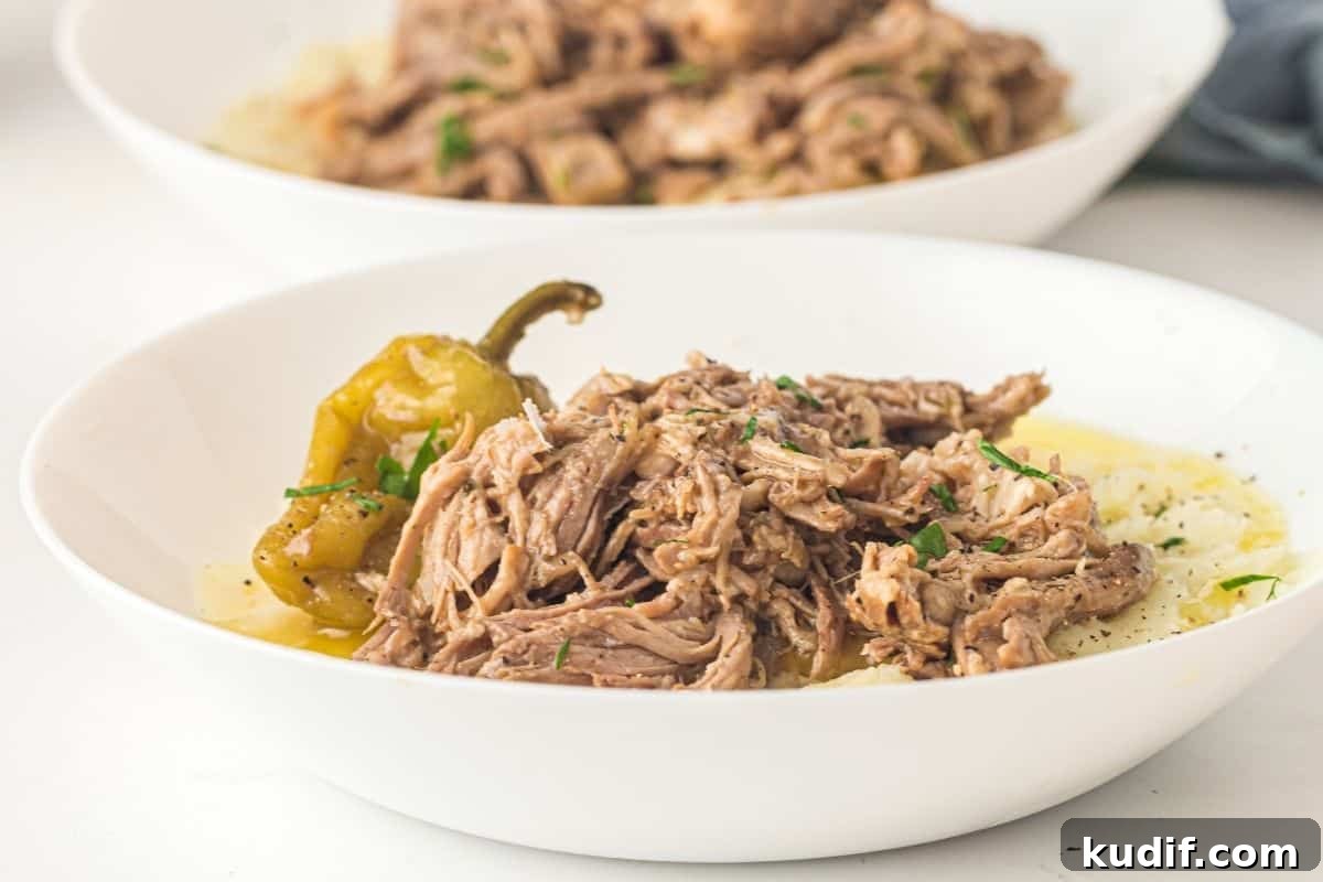 31 Delicious Recipes That Deliver Big Flavor with Little Effort 33 Mississippi Pork Roast garnish served over mashed potatoes in a white bowl.