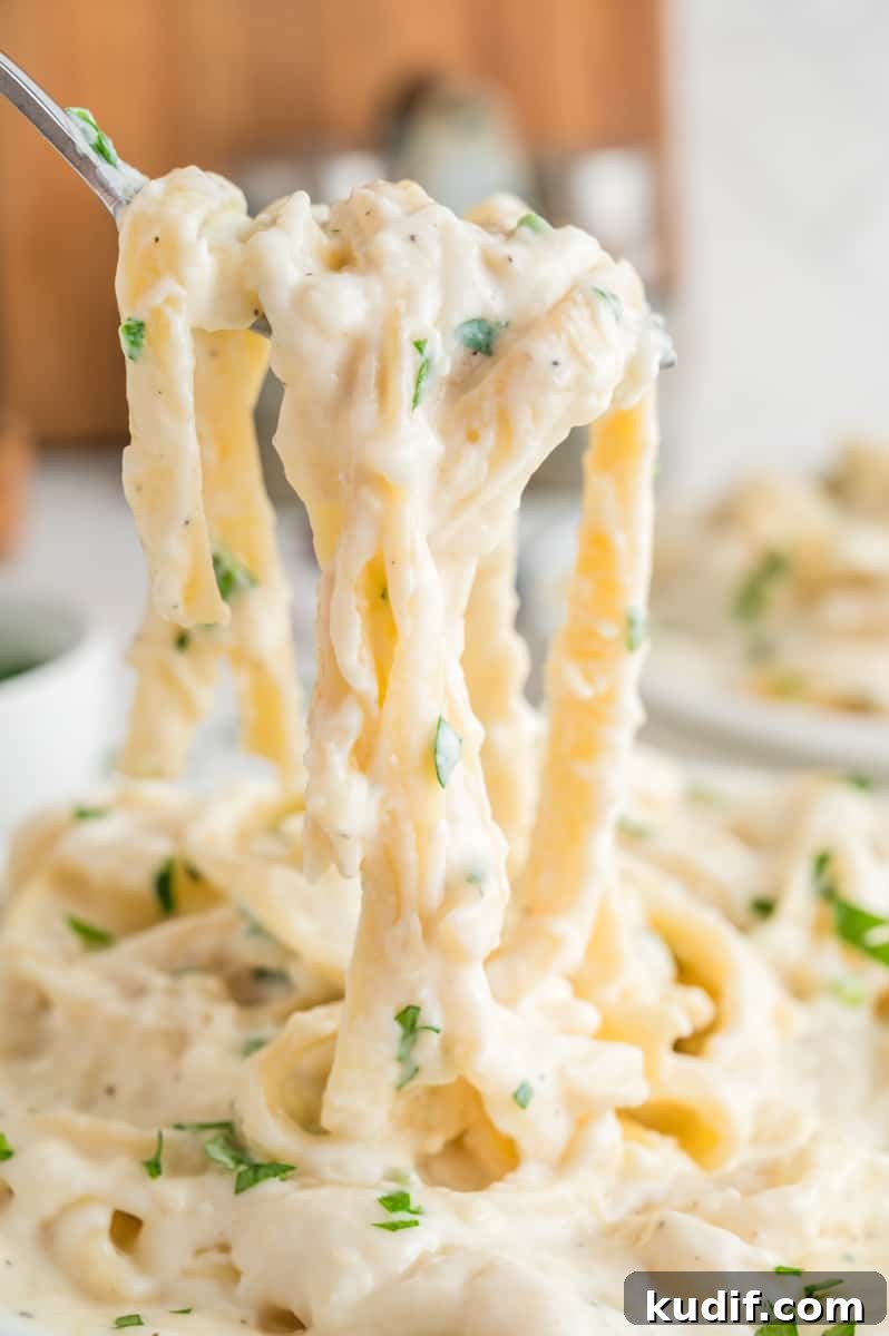 Creamy Homemade Alfredo Sauce Using Milk — Simple Recipe 2 Pasta in alfredo sauce on a fork.