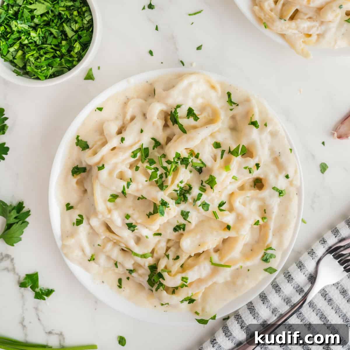 Creamy Homemade Alfredo Sauce Using Milk — Simple Recipe 3 A plate of fettuccine alfredo on a plate.