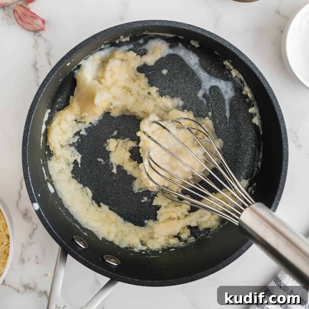 Creamy Homemade Alfredo Sauce Using Milk — Simple Recipe 6 Cooking a roux in a black pan.