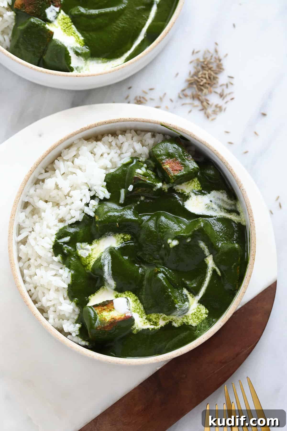 Palak paneer in a bowl with rice. 