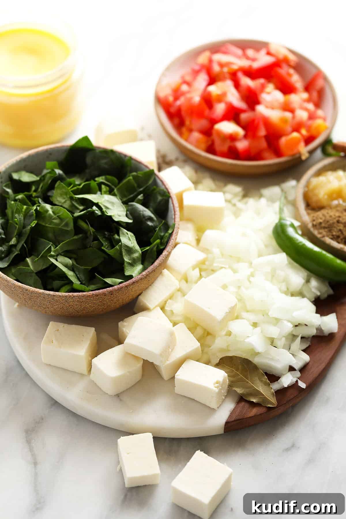 All the ingredients for palak paneer on a cutting board. 