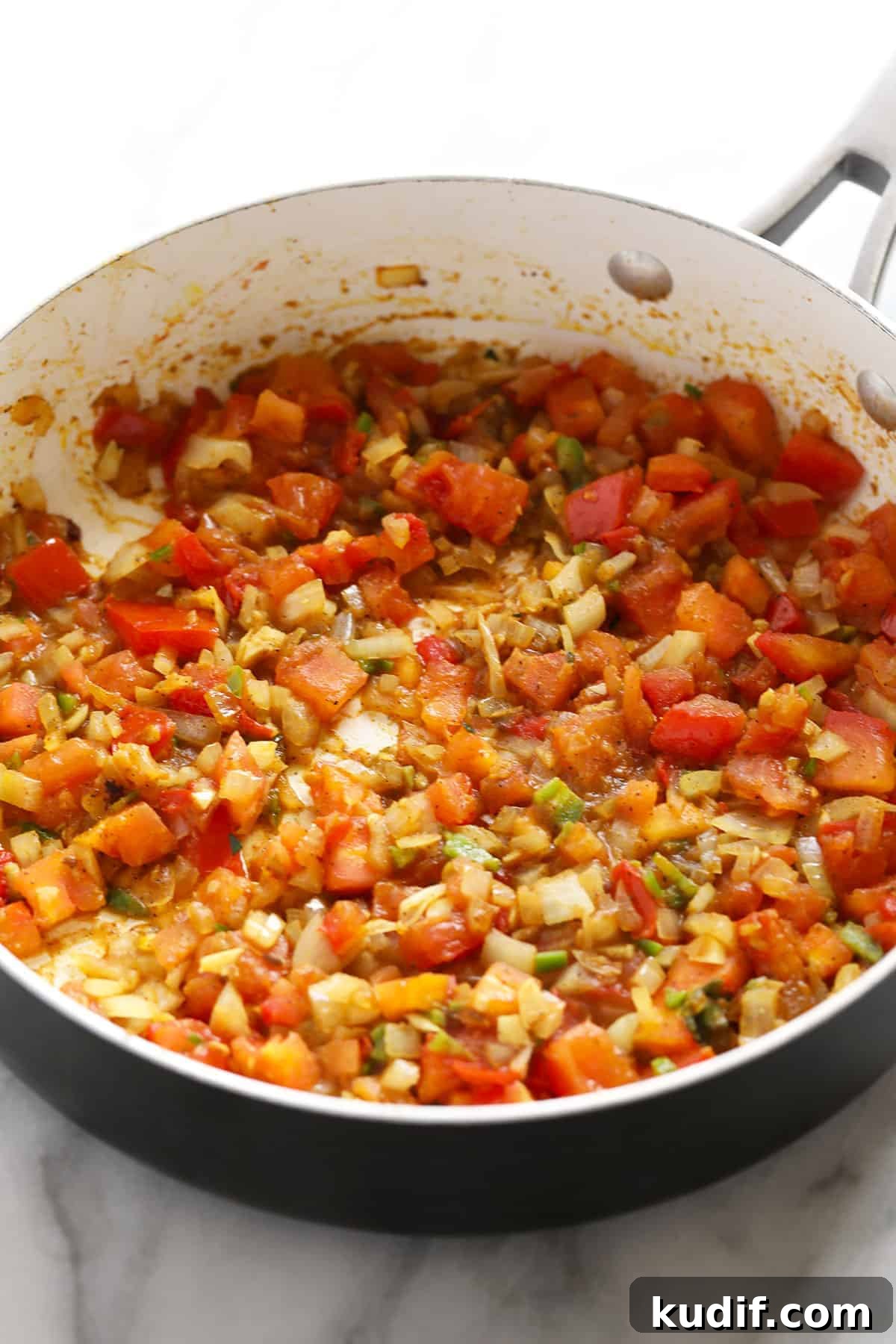 Palak paneer ingredients in a saute pan. 