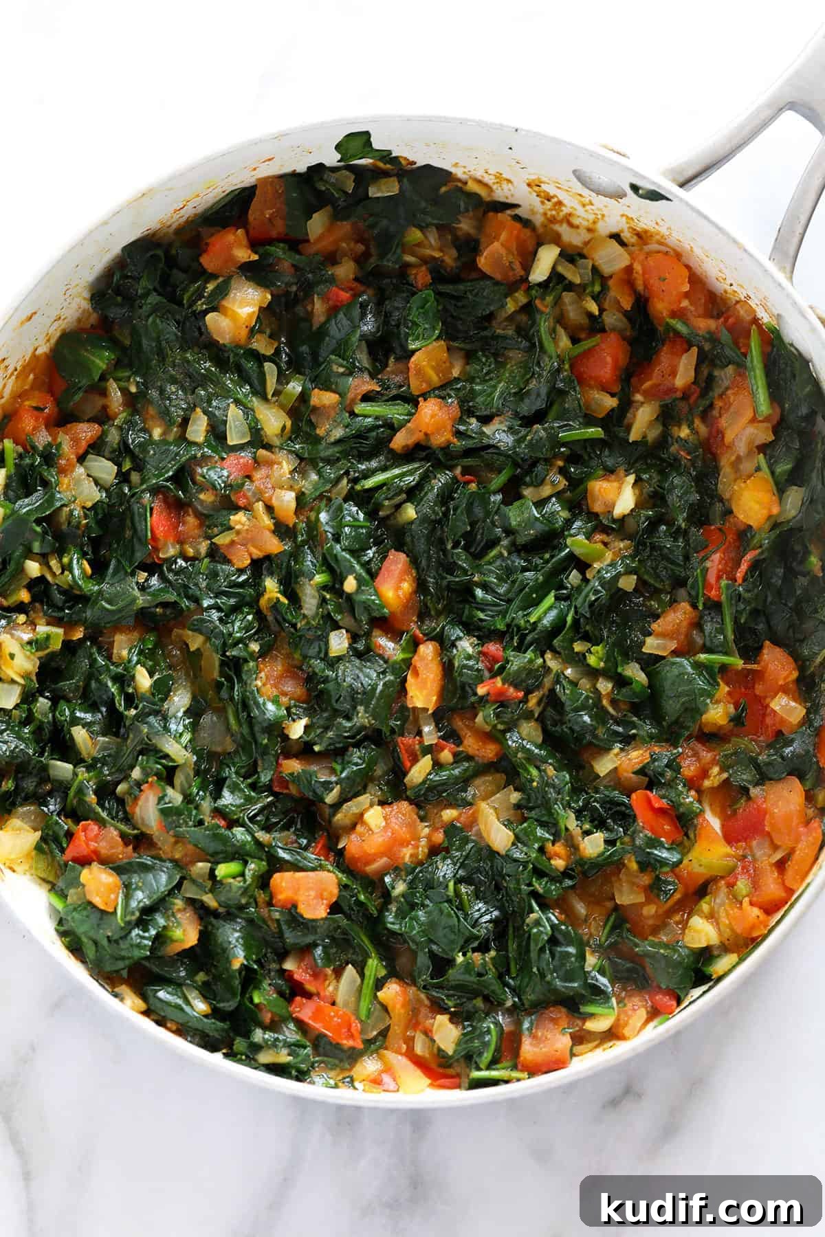 Spinach and other ingredients in a pan. 