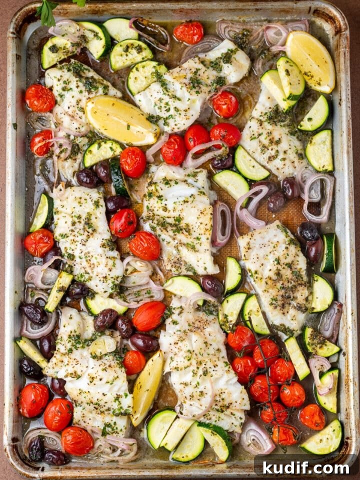 Mediterranean Sheet-Pan Baked Cod with Parsley Garlic Oil 2 sheet pan with tomatoes, shallot, cod fillets, zucchini, kalamata olives and lemon wedges