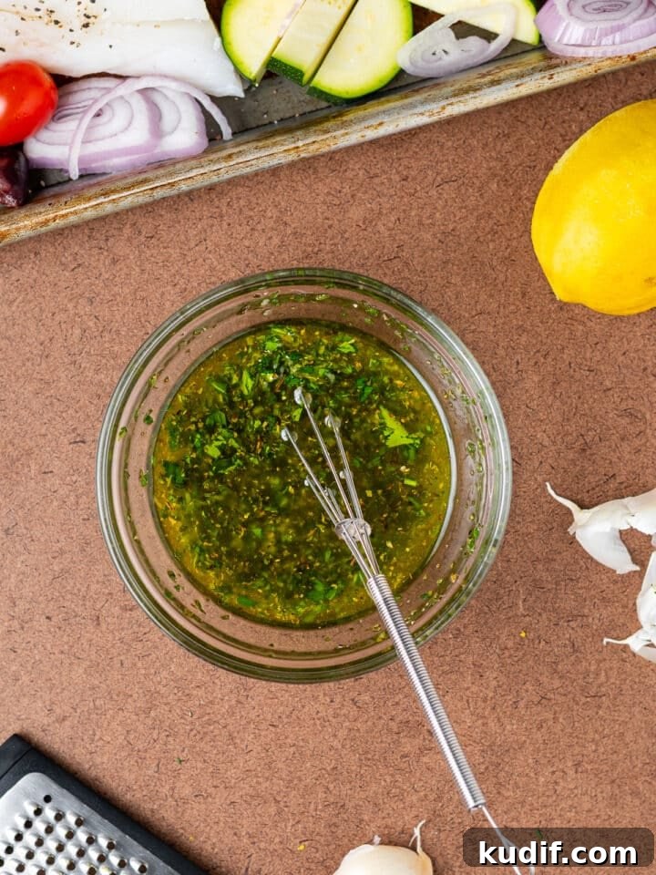 Mediterranean Sheet-Pan Baked Cod with Parsley Garlic Oil 8 whisk in a small bowl with parsley garlic oil