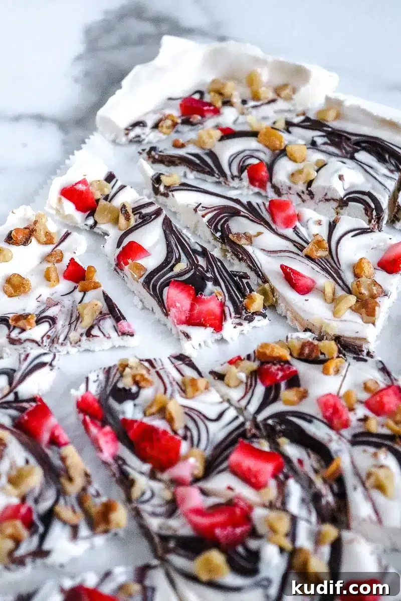 Strawberry Frozen Yogurt Bark Recipe — Quick Summer Dessert 7 frozen yogurt bark pieces with strawberries and chocolate