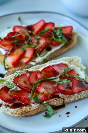 Strawberry ricotta toast topped with basil and balsamic.