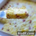 Spatula holding up slice of breakfast casserole.