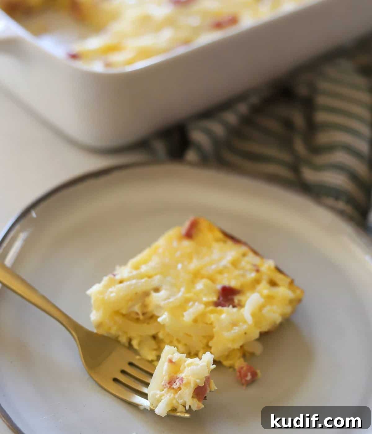 Cheesy Ham, Egg & Hashbrown Breakfast Casserole Recipe 9 Slice of ham egg hashbrown casserole on plate.