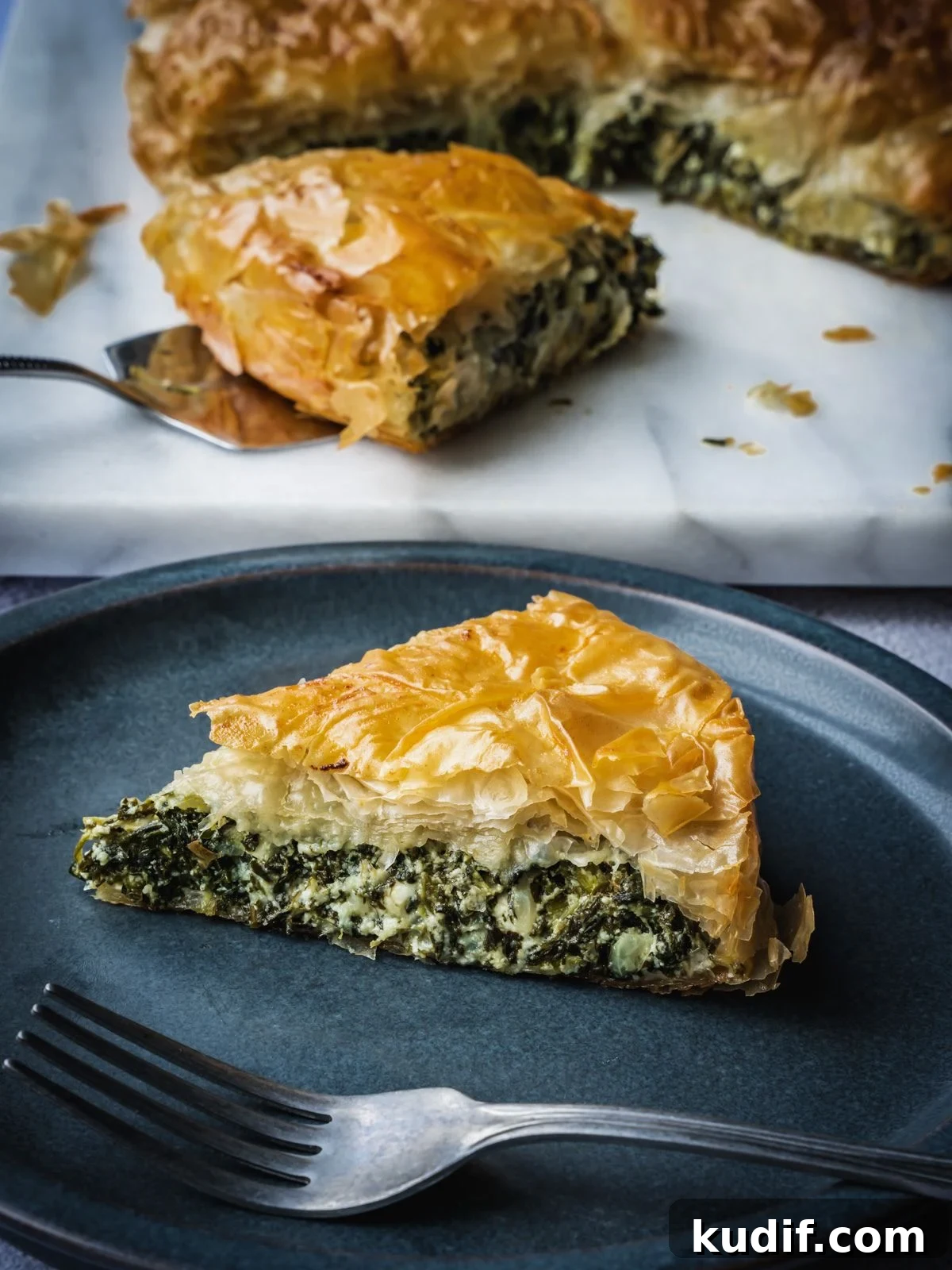 Authentic Spanakopita: Classic Greek Spinach Pie with Phyllo 2 Greek spinach pie slice on a plate.