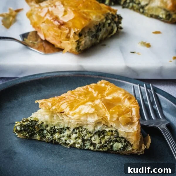 Greek spinach pie slice on a plate.