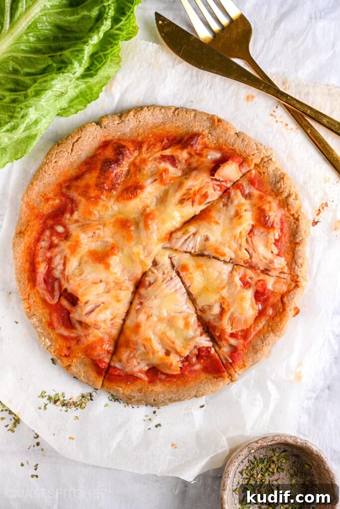 High-Protein Pizza Recipe for Muscle Gain and Recovery 13 Greek yogurt pizza base topped with shredded chicken cut into 3 slices, after baking ready to eat
