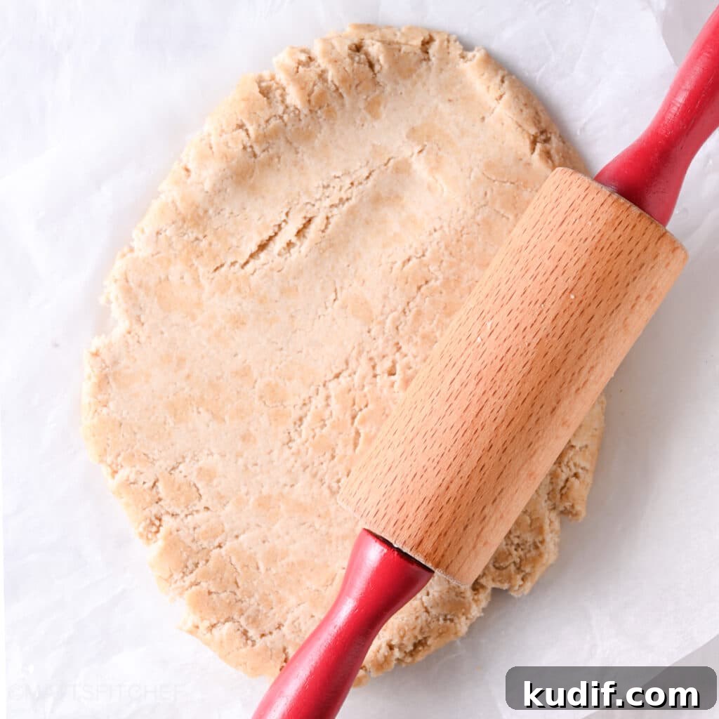 High-Protein Pizza Recipe for Muscle Gain and Recovery 6 Rolling Greek yogurt protein dough into a circle with a rolling pin.