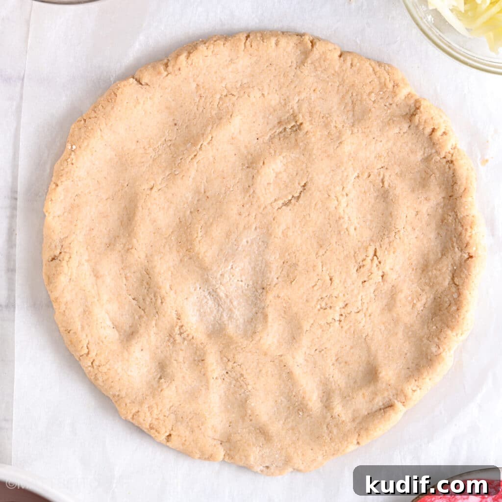 High-Protein Pizza Recipe for Muscle Gain and Recovery 8 High protein pizza crust after rolling, ready to be topped with tomato sauce, cheese and meat