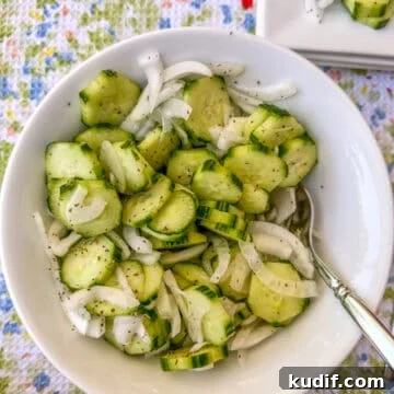 Crisp Quick Pickled Cucumbers Recipe for Homemade Snacks 13 A serving bowl of sliced cucumbers and onions.
