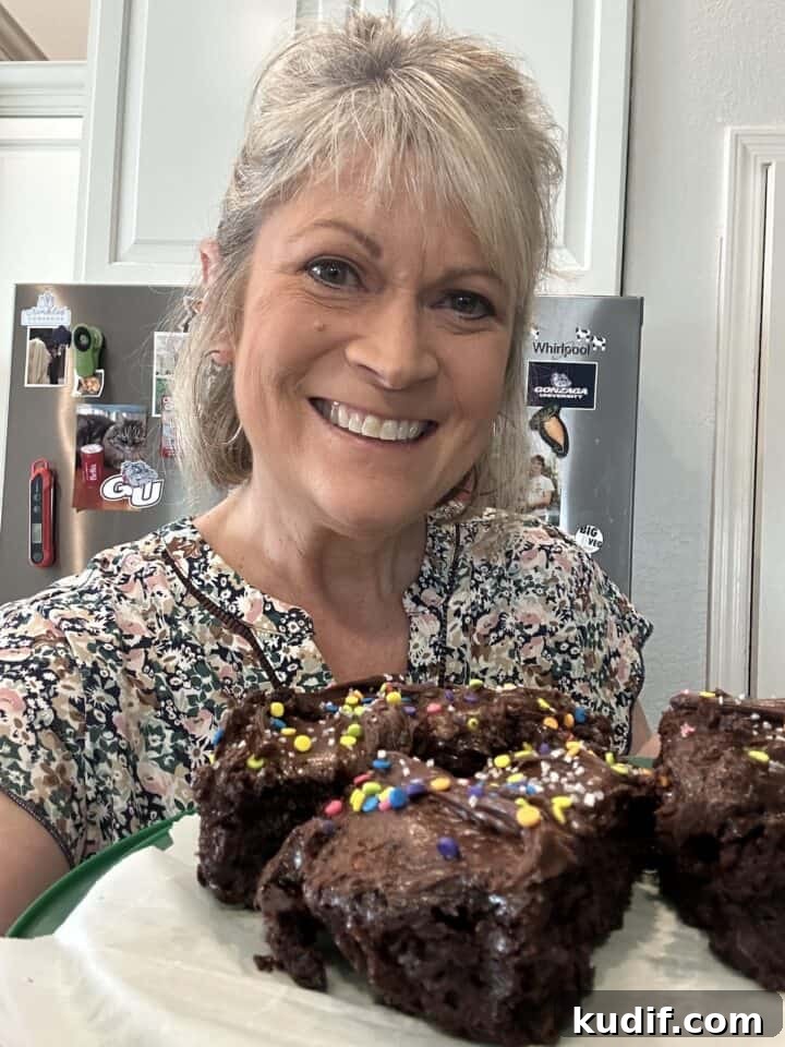 Crisp Quick Pickled Cucumbers Recipe for Homemade Snacks 3 Melinda in the kitchen holding a plate of chocolate cake slices.