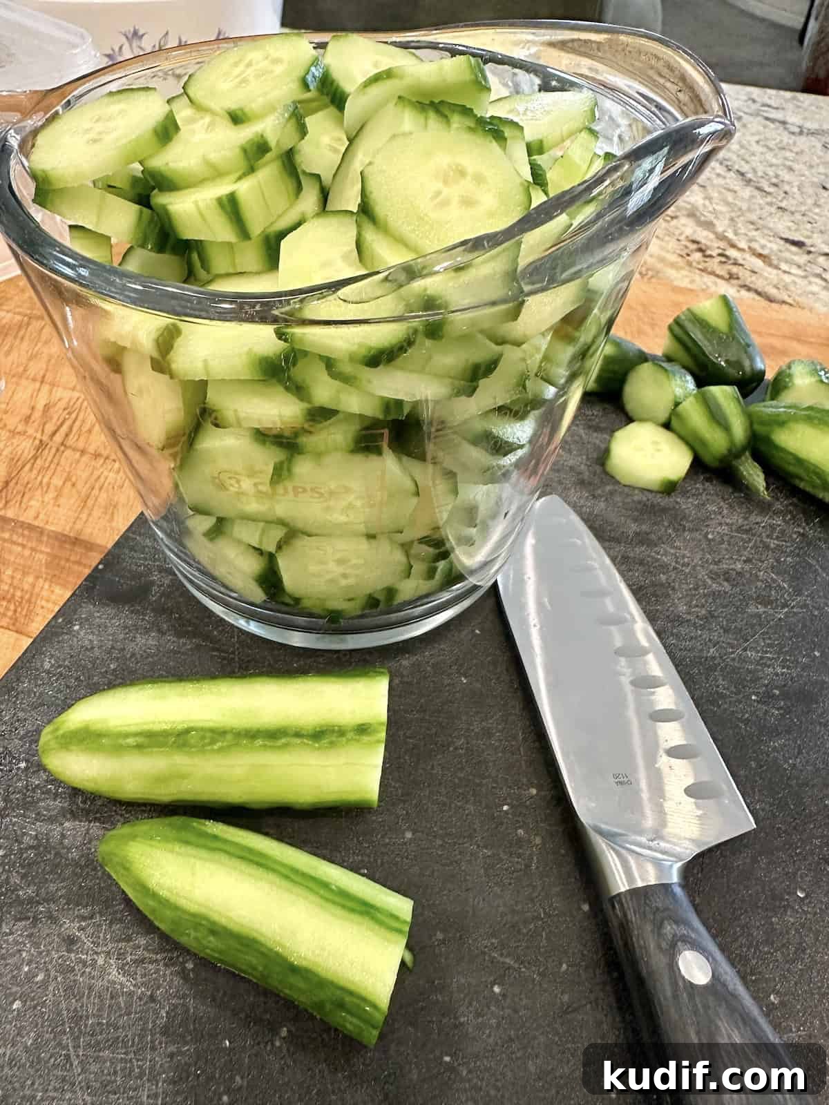 Crisp Quick Pickled Cucumbers Recipe for Homemade Snacks 5 Sliced cucumbers in a measuring cup.