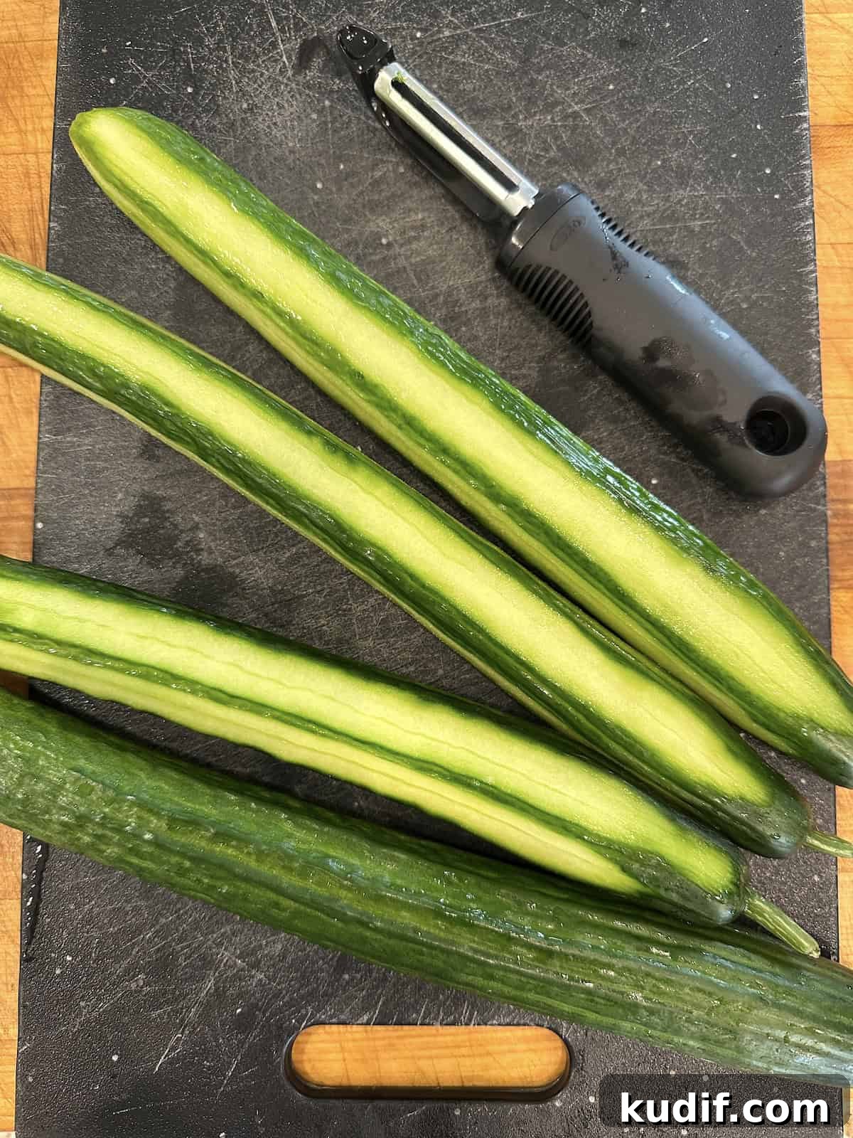 Crisp Quick Pickled Cucumbers Recipe for Homemade Snacks 7 Cucumbers half peeled for refrigerator pickles.