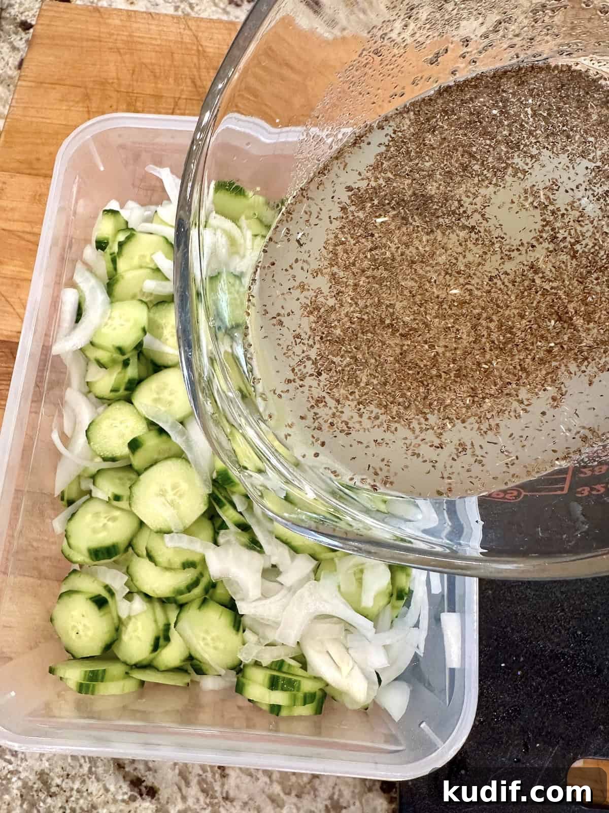 Crisp Quick Pickled Cucumbers Recipe for Homemade Snacks 9 Pouring brine over cucumber and onion slices.