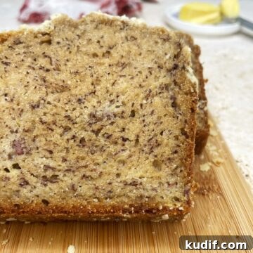 Sliced no sugar added banana bread on a wooden board.