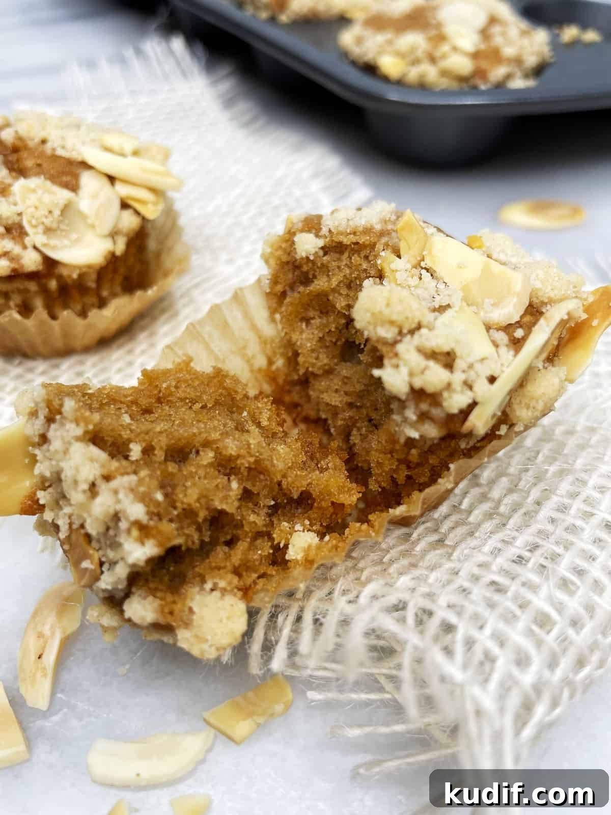 Halved mini banana muffin on a burlap ribbon