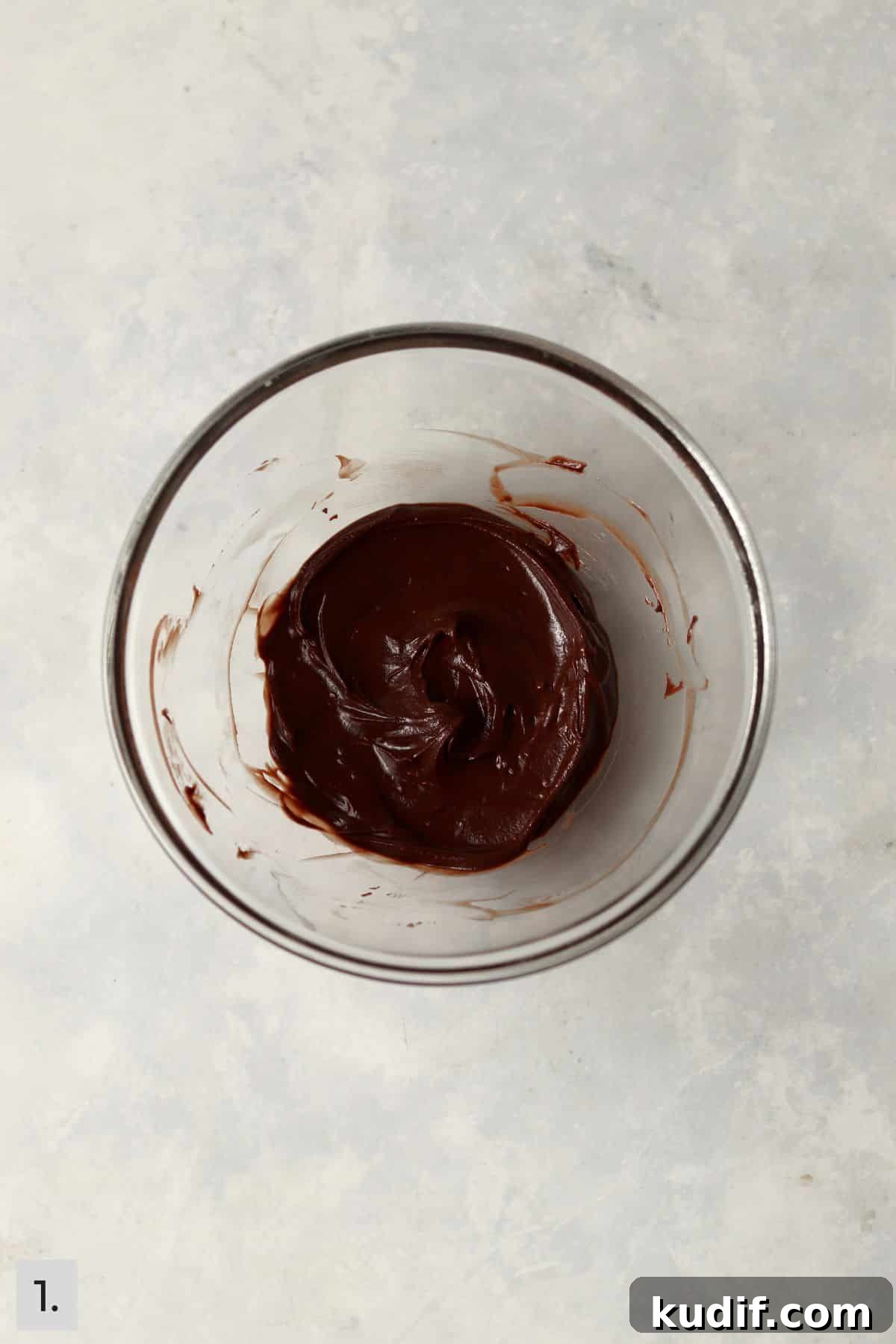 Melted chocolate in a small glass bowl.