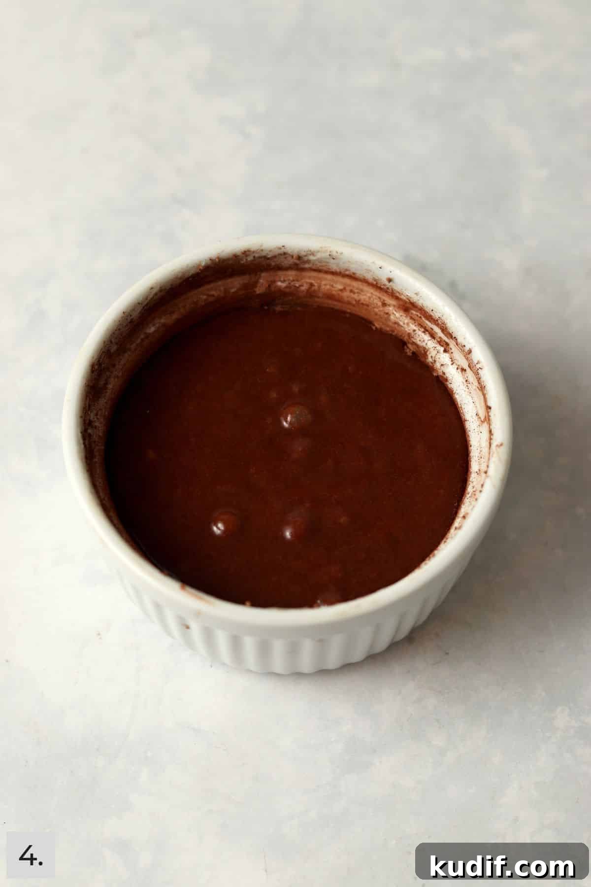 Unbaked single serve chocolate lava cake in a ramekin.