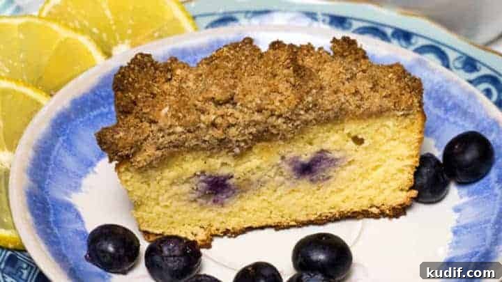 Coffee with Low Carb Lemon Blueberry Coffeecake with a crumb topping on blue and white plate set